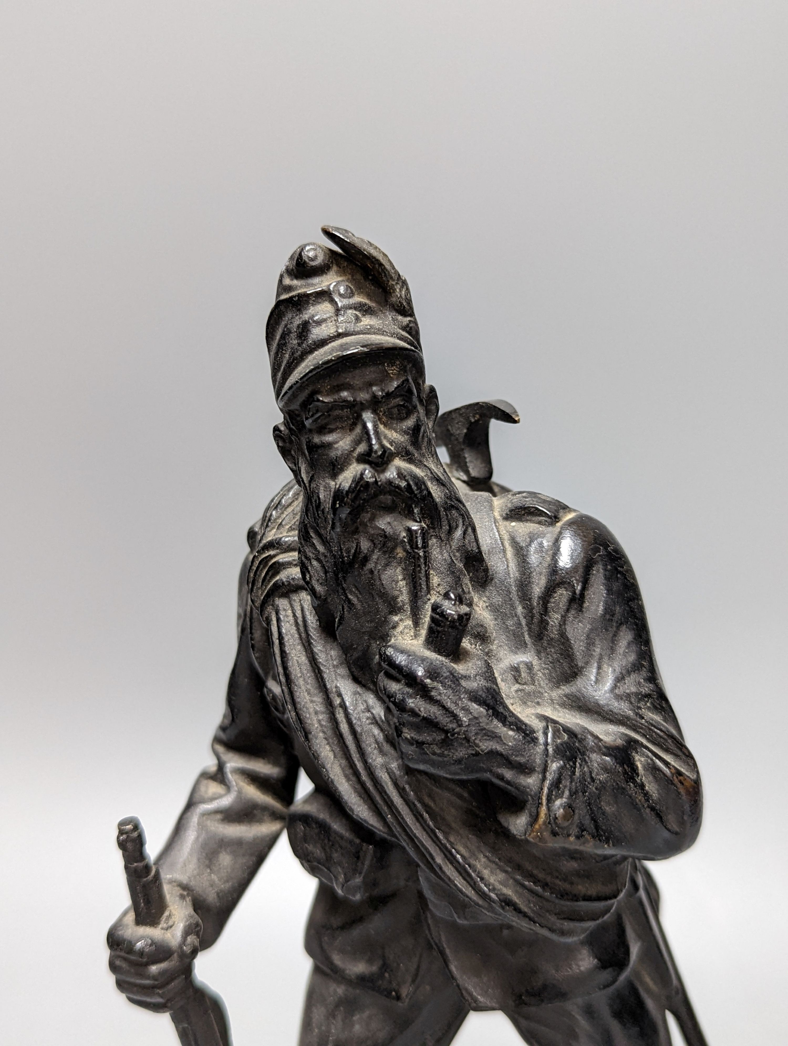 A WW1 period bronze figure of an Austrian soldier, 30 cms high including stone base.